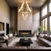 A luxurious living room with a modern fireplace, sofas, and a chandelier. Anteprima dell’immagine prodotto
