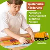A young boy is playing with a magnetic construction site puzzle on a table. Produktbild-Vorschau
