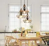 A dining room with a table and chairs, illuminated by pendant lights. Náhľad obrázku produktu