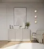 A modern living room scene featuring a sideboard, armchair, and artwork. Produktbild-Vorschau