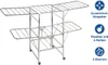 A mobile clothes dryer made of stainless steel, shown from a slightly elevated front-left angle against a white background. It has multiple levels and wheels. Náhled obrázku produktu