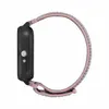 A side view of a smartwatch with a fabric strap. Voir les images du produit