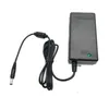 A black power adapter with a coiled black cord and a green indicator light. Podgląd zdjęcia produktu