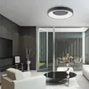 A modern living room with a large window overlooking an outdoor patio area. Produktbild-Vorschau