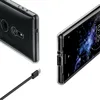 A clear protective case for a Sony Xperia XZ2 smartphone is shown from two angles, with a USB-C charging cable in the foreground. Produktbild-Vorschau