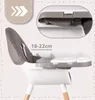 A close-up view of a high chair, highlighting adjustable features and dimensions. Voir les images du produit