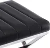 A close-up view of a black upholstered stool with a metal frame. Náhled obrázku produktu