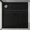 A top-down view of a black shower tray with a silver drain cover. Produktbild-Vorschau