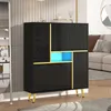 A modern black shoe cabinet with gold accents and blue LED lighting, placed in a living room setting. Anteprima dell’immagine prodotto