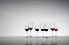 A collection of wine glasses filled with red wine, arranged on a reflective surface against a gradient background. Podgląd zdjęcia produktu