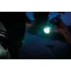 A hand holding a flashlight in the dark. Produktbild-Vorschau