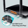 Close-up view of the back of a black router, showing the SIM card slot and Ethernet ports, with an inset diagram illustrating SIM card insertion. Podgląd zdjęcia produktu