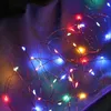 A close-up of colorful LED string lights on a textured purple and blue background. Produktbild-Vorschau