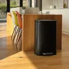 A black kitchen trash can with a pedal is placed next to a wooden kitchen island with colorful chairs. Podgląd zdjęcia produktu