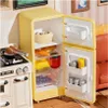 A miniature yellow refrigerator filled with food items, placed next to a miniature stove. Podgląd zdjęcia produktu