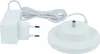 A white charging station and power adapter for a Toniebox. Produktbild-Vorschau