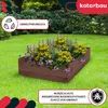 A wooden raised garden bed filled with flowers, set on a green lawn with a background of trees and bushes. Podgląd zdjęcia produktu