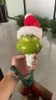 A hand holding a Grinch-themed Christmas tree decoration. Produktbild-Vorschau