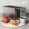 A Balter toaster is shown on a kitchen counter with toast, jam, apricots, and coffee, suggesting a breakfast setting. Produktbild-Vorschau