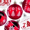 A collection of red and white Christmas ornaments with festive patterns. Produktbild-Vorschau