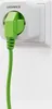 A green plug is inserted into a white LEDVANCE smart plug which is plugged into a white wall socket. Náhled obrázku produktu
