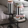A close-up shot of Villeroy & Boch Memphis Home Vases and a decorative sphere on a side table next to a sofa. Voir les images du produit