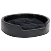 A black oval dog bed with a plush interior, shown from a slightly elevated side angle against a white background. Produktbild-Vorschau