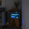 A wooden cabinet with blue LED lighting is shown in a dimly lit room next to a sofa. Produktbild-Vorschau