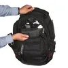 A person's hands are shown interacting with the main compartment of a black Ogio backpack. Produktbild-Vorschau