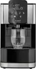 A close-up shot of a hot water dispenser with steam rising from the spout into a glass. Anteprima dell’immagine prodotto