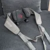 A gray neck and back massager with red indicator lights is placed on a gray couch. Produktbild-Vorschau
