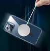 A hand is holding a charging cable connected to a magnetic ring on the back of a clear phone case, with a blurred background suggesting motion. Anteprima dell’immagine prodotto