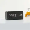 A digital clock on a white surface with a blurred background. Voir les images du produit