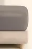 A close-up view of a mattress topper on a bed base. Podgląd zdjęcia produktu