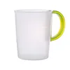 A clear measuring cup with a green handle against a white background. Produktbild-Vorschau