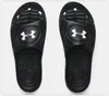 A pair of black Under Armour slides shown from a top-down view against a white background. Anteprima dell’immagine prodotto