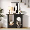 A console table with decorative items placed on and inside it, next to a staircase. Produktbild-Vorschau
