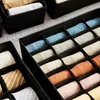 The image displays a set of fabric storage organizers filled with rolled-up items, likely clothing such as socks or ties. Produktbild-Vorschau
