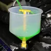A close-up shot of a coolant funnel kit being used to fill a car's engine with green coolant. Podgląd zdjęcia produktu