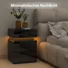 A modern black nightstand with LED lighting next to a bed. Produktbild-Vorschau
