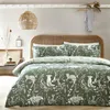 A bedroom scene with a bed made up with green bedding featuring a woodland animal print. Voir les images du produit