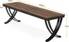 A long, narrow wooden table with black metal legs is shown from a diagonal angle. Podgląd zdjęcia produktu