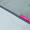 A close-up view of a gray pet step with a pink tag attached. Podgląd zdjęcia produktu