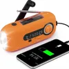 An orange emergency radio is shown charging a smartphone. Produktbild-Vorschau