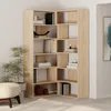 A corner bookshelf unit filled with books and decorative items, placed in a room setting with a plant and ottoman. Produktbild-Vorschau