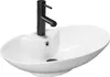 A white oval basin sink with a black faucet against a white background. Náhled obrázku produktu