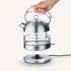 A hand is holding a glass electric kettle over its base. Produktbild-Vorschau
