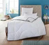 A neatly made bed with a white comforter and pillows in a bedroom setting. Produktbild-Vorschau