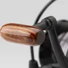 A close-up shot of a fishing reel handle. Podgląd zdjęcia produktu