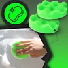 A hand is shown using a green sponge to clean a white surface, likely a car, covered in soap suds. Two green sponges are also shown in the upper right corner, and a green circular icon with a sparkle symbol is in the upper left. Podgląd zdjęcia produktu